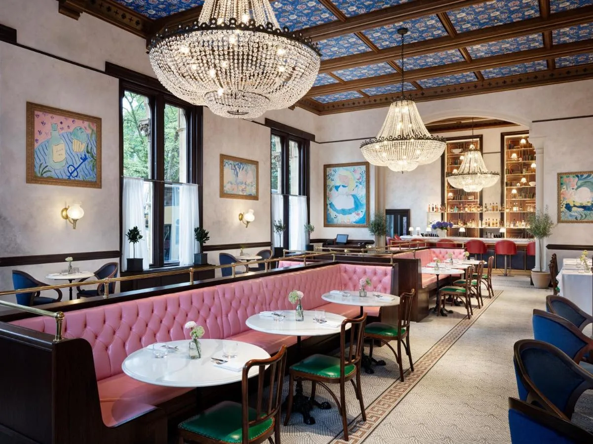 Restaurant with tables, chairs and chandeliers at The Randolph Hotel Oxford