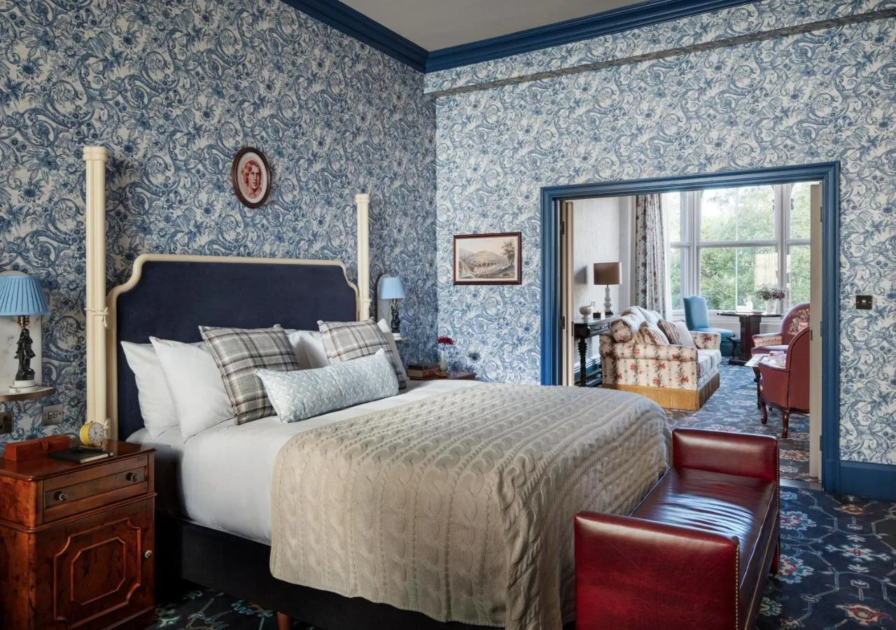 Bedroom with blue wallpaper at The Randolph Hotel Oxford