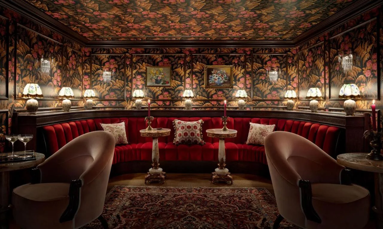 Red booth against patterned wallpaper at The Randolph Hotel Oxford